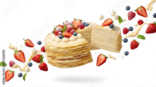 Isolated strawberry crepe cake with flying berries and cream splashes ideal for dessert menu advertising and culinary content