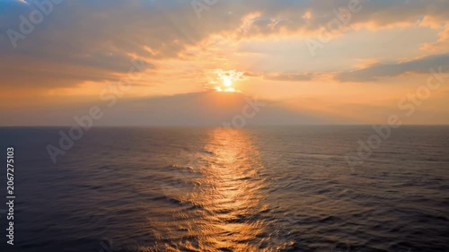 Golden Sunset Reflection on Moving Ocean Waves at Dusk. Seamless looping 4k video background 