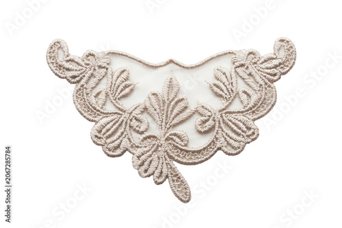 An intricate beige lace applique with floral embroidery, isolated on a white background, sewing, fashion, and textile projects