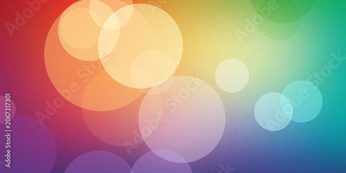Fotografija Abstract background with overlapping bokeh circles in rainbow colors creating soft festive atmosphere and textured light gradient