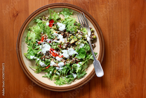 Healthy green salad mixed with Quinoa, peas and mini broad beans.