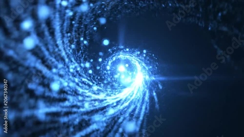 Abstract blue glowing bokeh particles on dark background.
