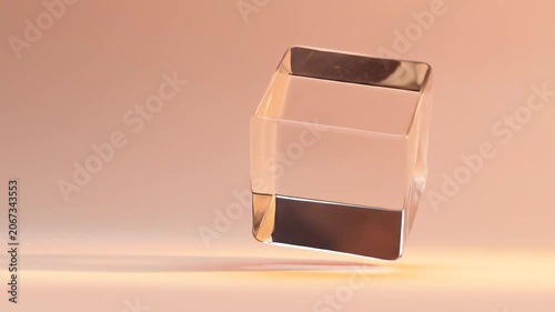 Transparent geometric cube floating in warm lighting simple composition