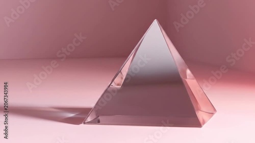 Transparent pyramid on pink surface abstract geometric shape concept