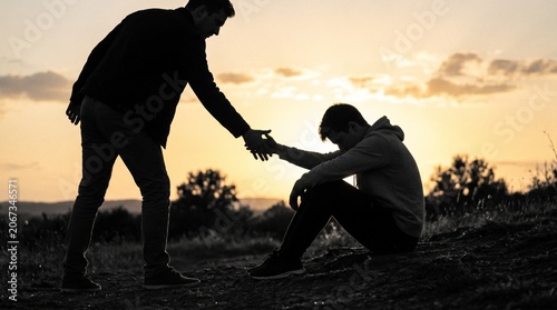 Realistic photo of silhouette of person offering help to another during sunset made by AI generative