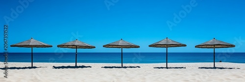 Tropical beach with colorful umbrellas on sandy shore by the ocean under a sunny sky
