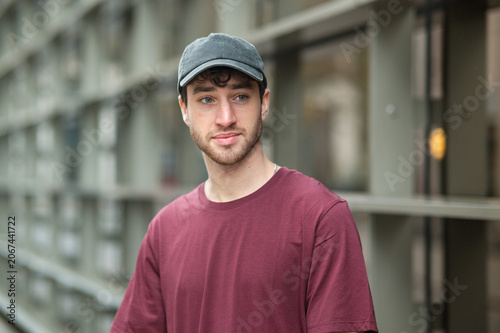 Young man wearing cap posing in urban setting