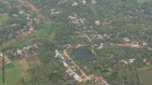 Aerial Landscape View Over Green Fields, River Bends, and Patchwork Farmland with Rural Roads Beneath Soft Haze