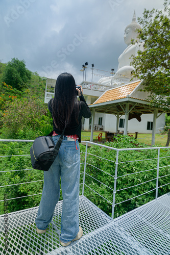 фотографія Woman Traveling and Photographing Wat Than Namtok in Thailand