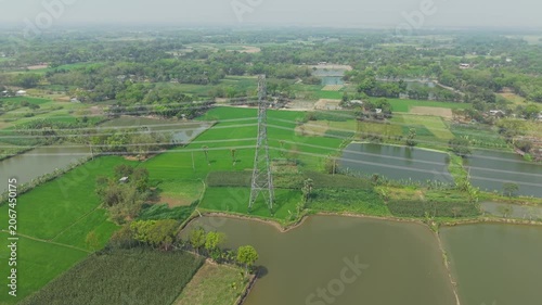 Aerial Landscape View of Green Agricultural Fields with a Winding River and Distant Patchwork Farms Under Clouds