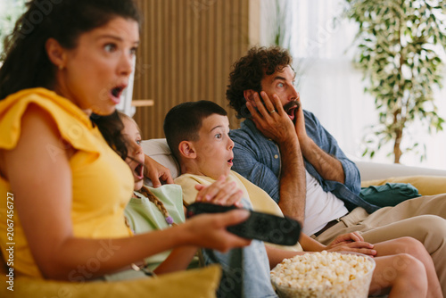Vászonkép Family expressing shock watching thrilling tv at home