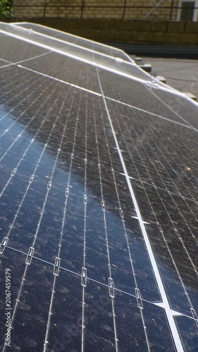 The Concept of Green Energy in an Urban Environment. Solar panels on the roofs of old apartment buildings. A rooftop solar power plant - Vetical video