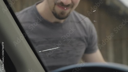 Male person check the fractured windscreen on the car view from inside 4K