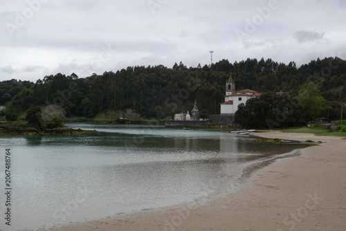 Historic Church of Nuestra Senora de los Dolores in Niembro estuary, vintage style with empty space for Asturias travel design and scenic tourism in Spain