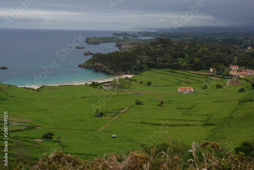 Spectacular Torimbia beach with wild cliffs and green hills in Asturias, vintage style with empty space for Northern Spain travel design and nostalgic cinematic nature