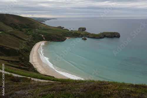 Spectacular Torimbia beach with wild cliffs and green hills in Asturias, vintage style with empty space for Northern Spain travel design and nostalgic cinematic nature