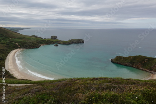 Spectacular Torimbia beach with wild cliffs and green hills in Asturias, vintage style with empty space for Northern Spain travel design and nostalgic cinematic nature