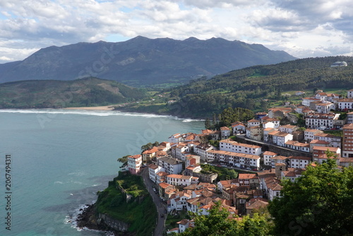 Scenic coastal village of Lastres with traditional houses on the cliff in Asturias, vintage style with empty space for Northern Spain travel design and nostalgic cinematic tourism