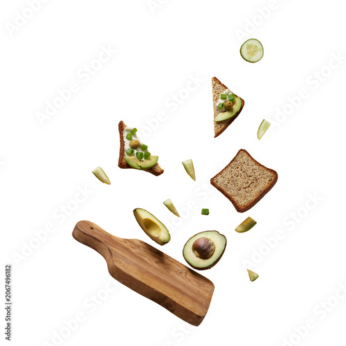 Levitating avocado toast, fresh ingredients, and a wooden cutting board
