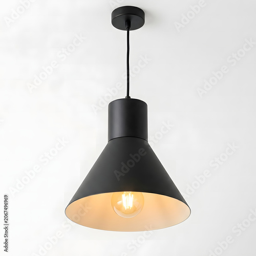 Modern matte black pendant lamp with a warm glowing light bulb hanging against white wall