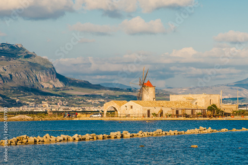 Trapani sea salt production view of old windmill at salt marches in Sicily, Italy