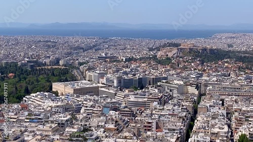 Athens aerial pan over crowded cityscape past Parthenon Acropolis Greece