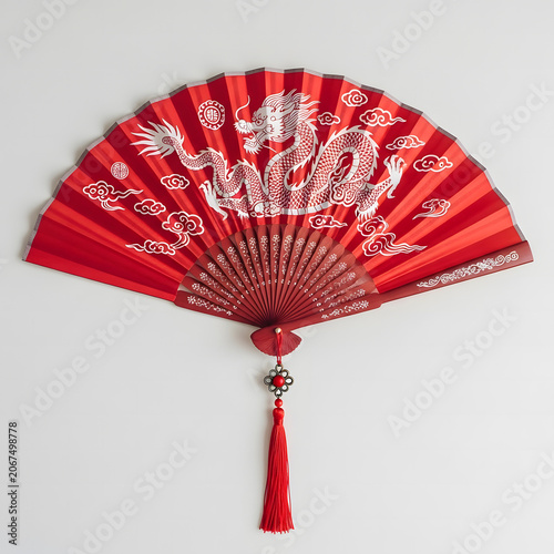 Traditional folding fan featuring an intricate white dragon illustration on vibrant red satin fabric material