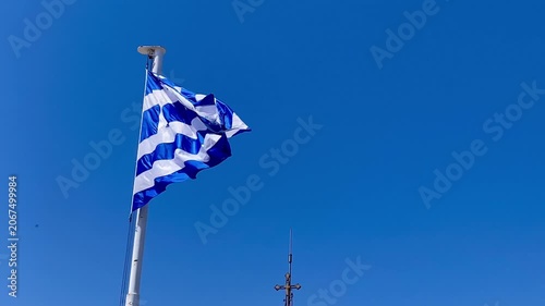 Greek flag flying in breeze against blue sky Athens Greece