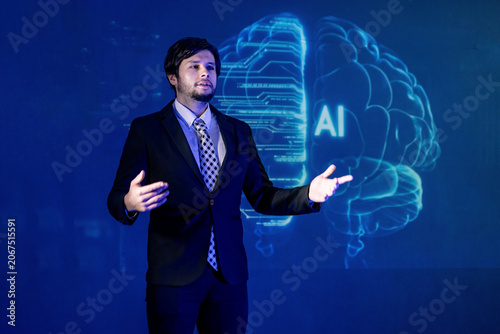 Man presents ideas on artificial intelligence in business during a conference in a large room at night