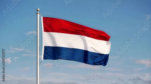Dutch flag waving in the wind against a bright blue sky, vertical video featuring vibrant national colors, patriotic atmosphere and realistic fabric movement