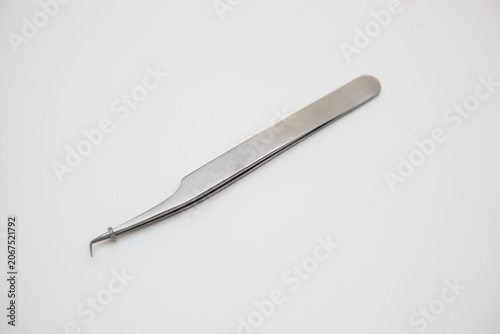 tools for eyelash extension and eyebrow design. cosmetic tweezers in silver color on a white background