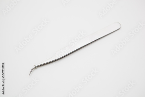 tools for eyelash extension and eyebrow design. cosmetic tweezers in silver color on a white background