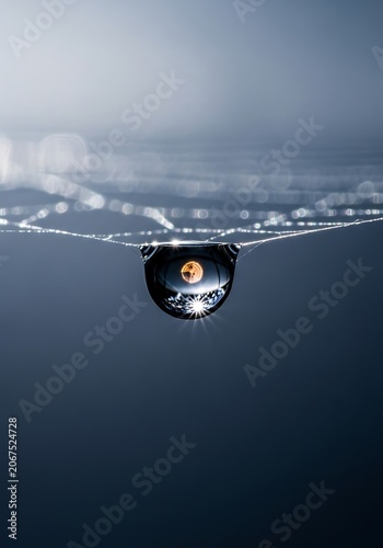 Close-up view of a car wheel on a wet road at night.