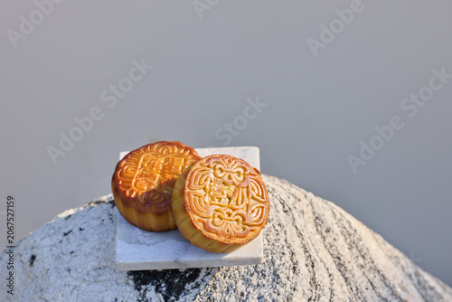 Golden Mooncakes on Porcelain Plate Between Gravels