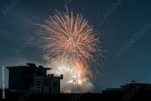 Gorgeous Fireworks Display Over City Buildings at Night Sky