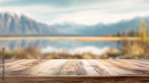 Cinematic nature scene with a wooden tabletop and blurred mountains over a reflective lake