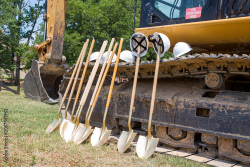 Groundbreaking Ceremony Preparations with Excavator and Shovels at Construction Site