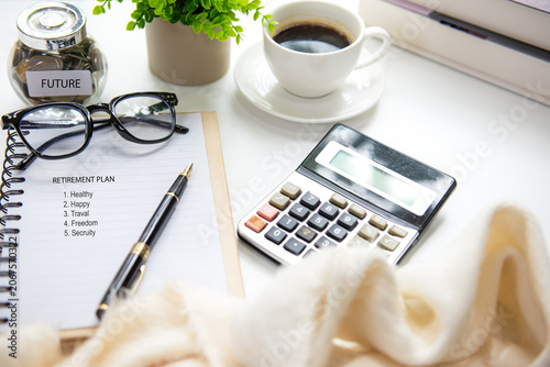Retirement planning with saving jar, calculate and notebook for future financial security.  Financial Wellness for retirement Concept