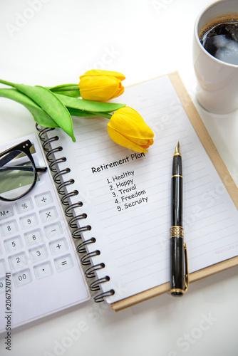 Retirement planning with saving, calculate notebook and tulip flower for future financial security.  Financial Wellness for retirement Concept