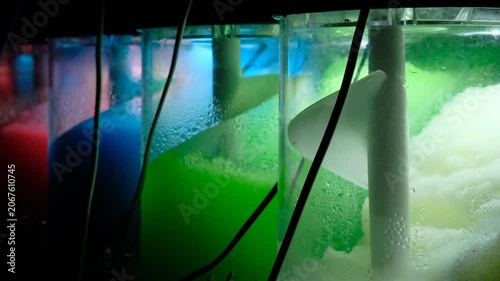 Ice cold sorbet machine mixing fruit juice. Freezing slush spinning around, summer treat. Crushed iced coloured with fruit flavor sweeteners 