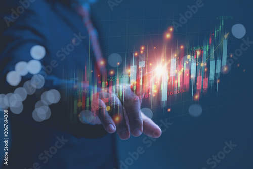 A businessman analyzing a stock market candlestick chart for Financial Investment Growth.