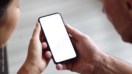 Hand holding smartphone with blank white screen.