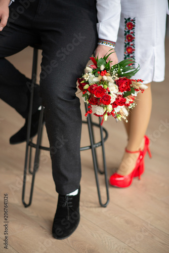 bride and groom in embroidered Ukrainian dresses. A beautiful bouquet