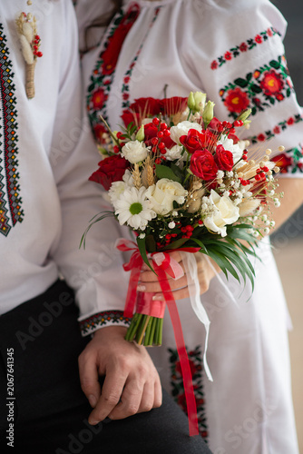 bride and groom in embroidered Ukrainian dresses. A beautiful bouquet