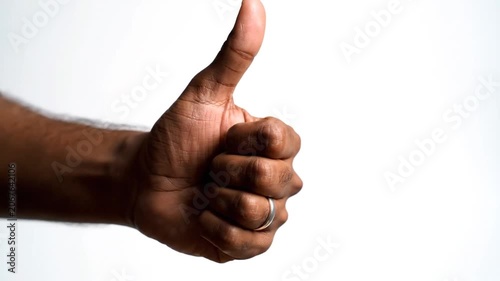 Hand showing thumbs up gesture on white background