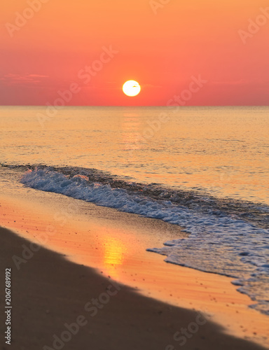 Sunrise Over a Calm Ocean Beach