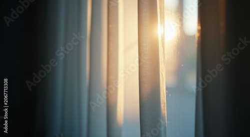 Sunlight shining through a window with curtains in the foreground