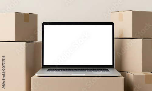 Unused Laptop Amidst Boxes and Shipping Supplies
