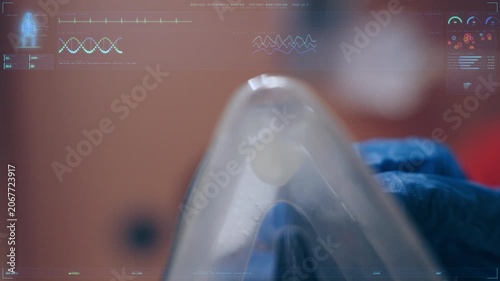 Medical oxygen mask held by a gloved hand with a futuristic HUD interface overlay displaying vital signs and patient data, representing emergency healthcare and virtual medicine