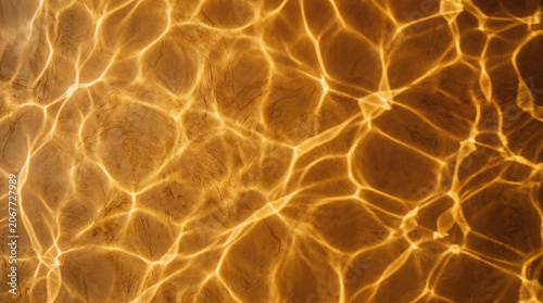 Close up texture of golden cracked earth surface with intricate vein patterns in warm natural light